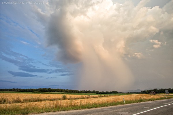 Rain shaft illuminated with warm evening light.