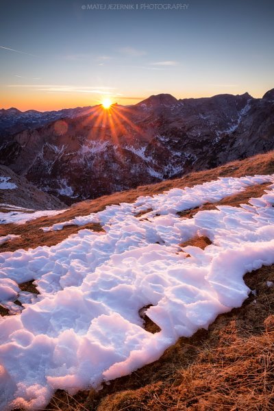 Sun is setting behind the Mount Krn on december evening in the Julian Alps. 