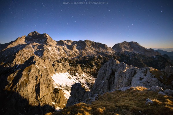 Mount Triglav illuminated by moonlight as seen on late december evening from mount Tosc. 